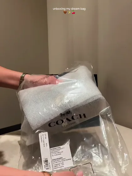 @hiits.cassie filming a coach unboxing